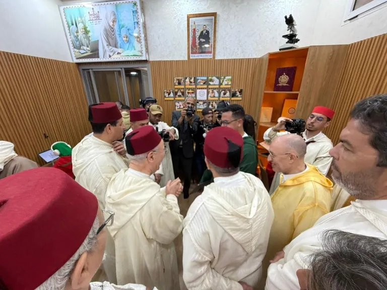 Officials gathered in the AI Quranic education room during the official visit.